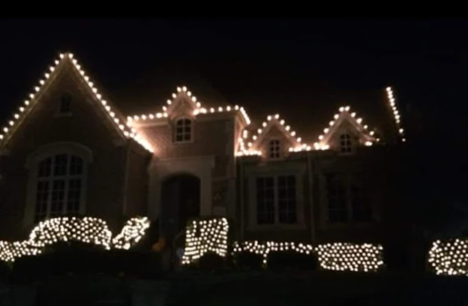 Warm white Christmas lights along a home roofline